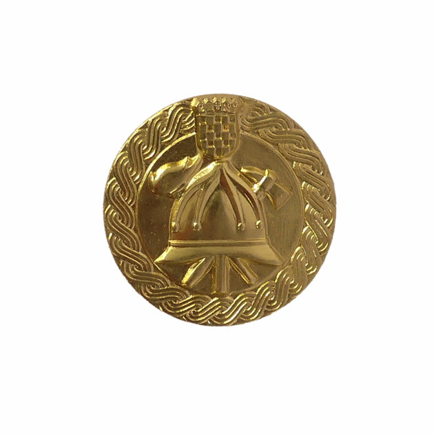 An metal emblem for an antique fireman's helmet